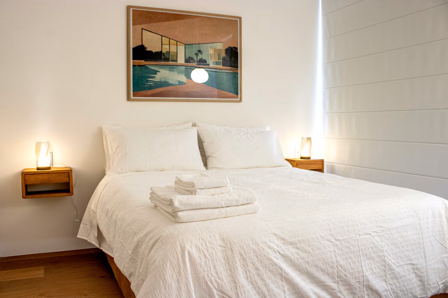 Bedroom with king bed and contemporary art