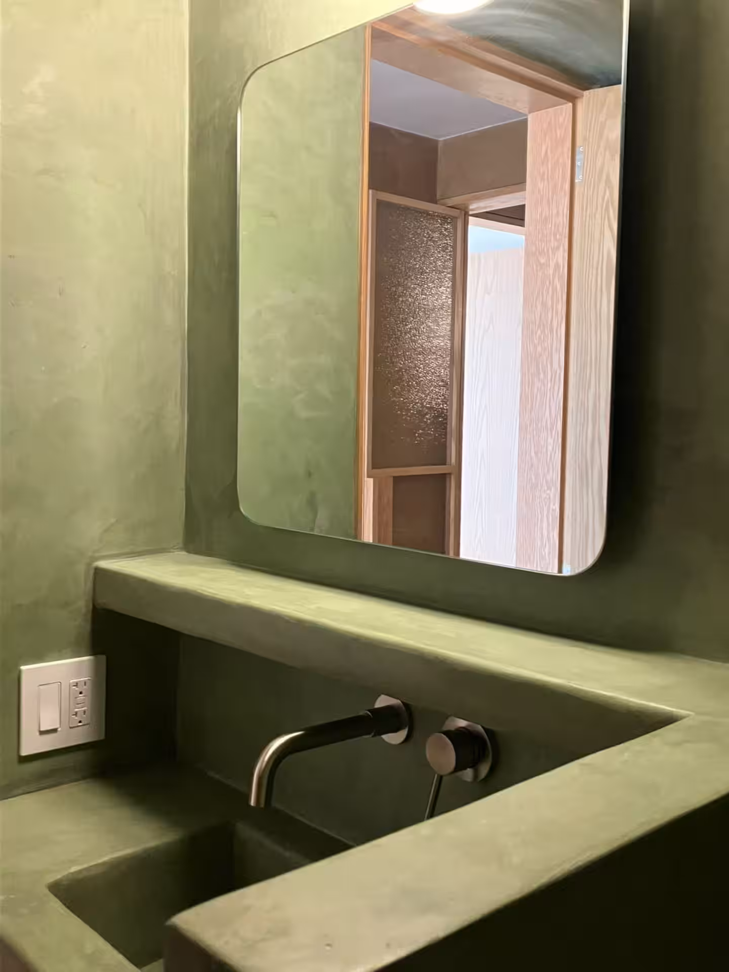 Green concrete sink with mirror